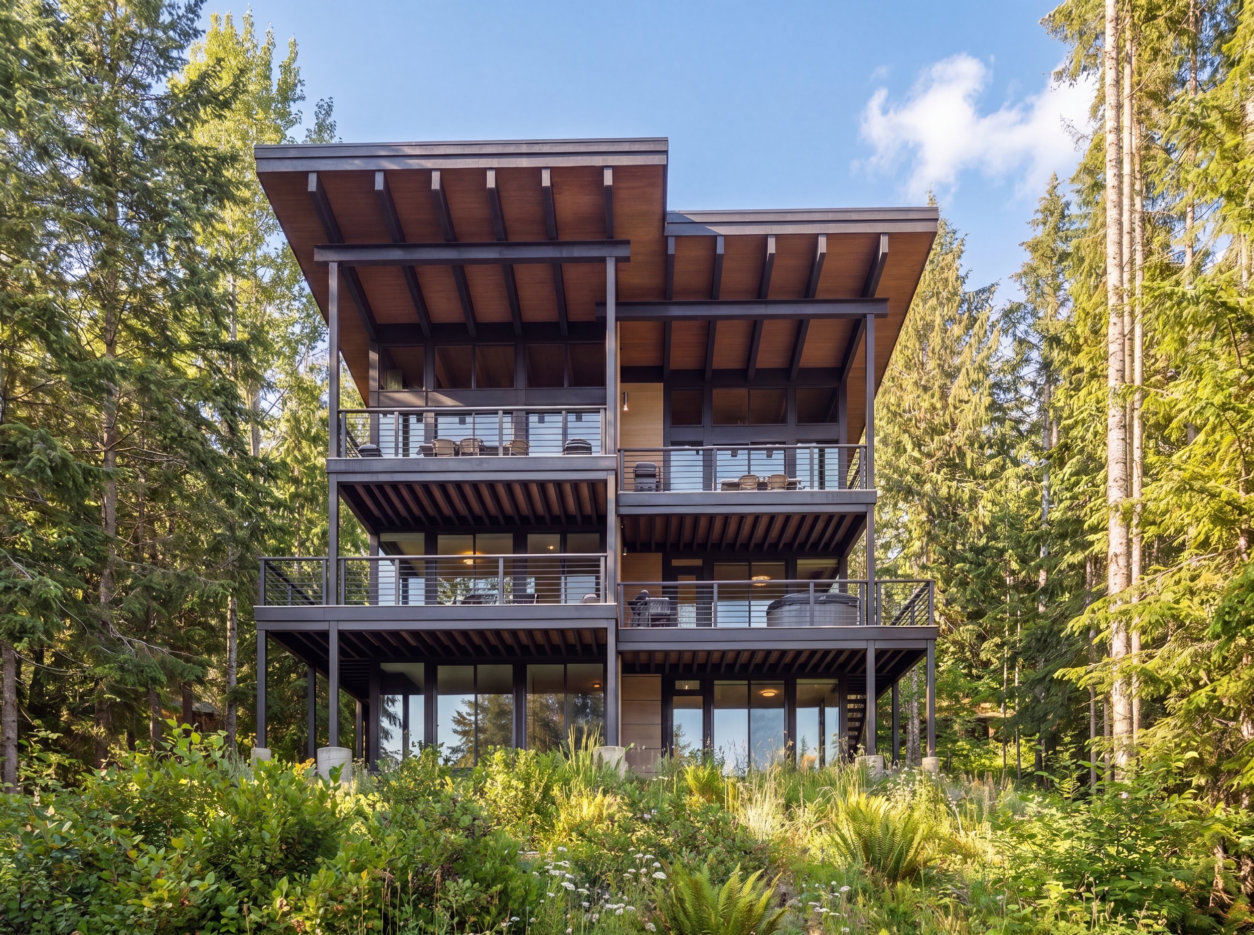 The Mountainside House — Snoqualmie Pass architecture by Terralite Design, a custom home at Hyak with tall glass walls and stacked decks
